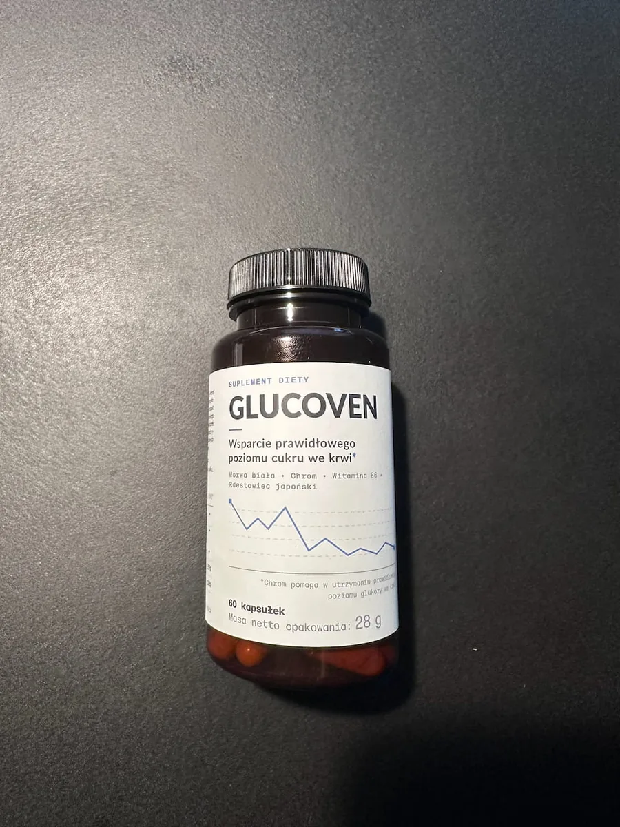 Butelka suplementu Glucoven stojąca na ciemnoszarym blacie w nastrojowym oświetleniu