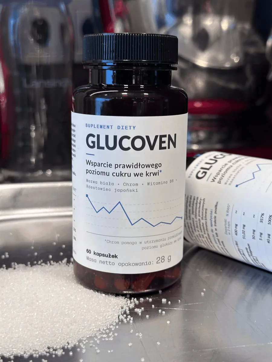 Butelka Glucoven na stalowym blacie kuchennym obok rozsypanego cukru, w tle druga butelka leżąca na boku